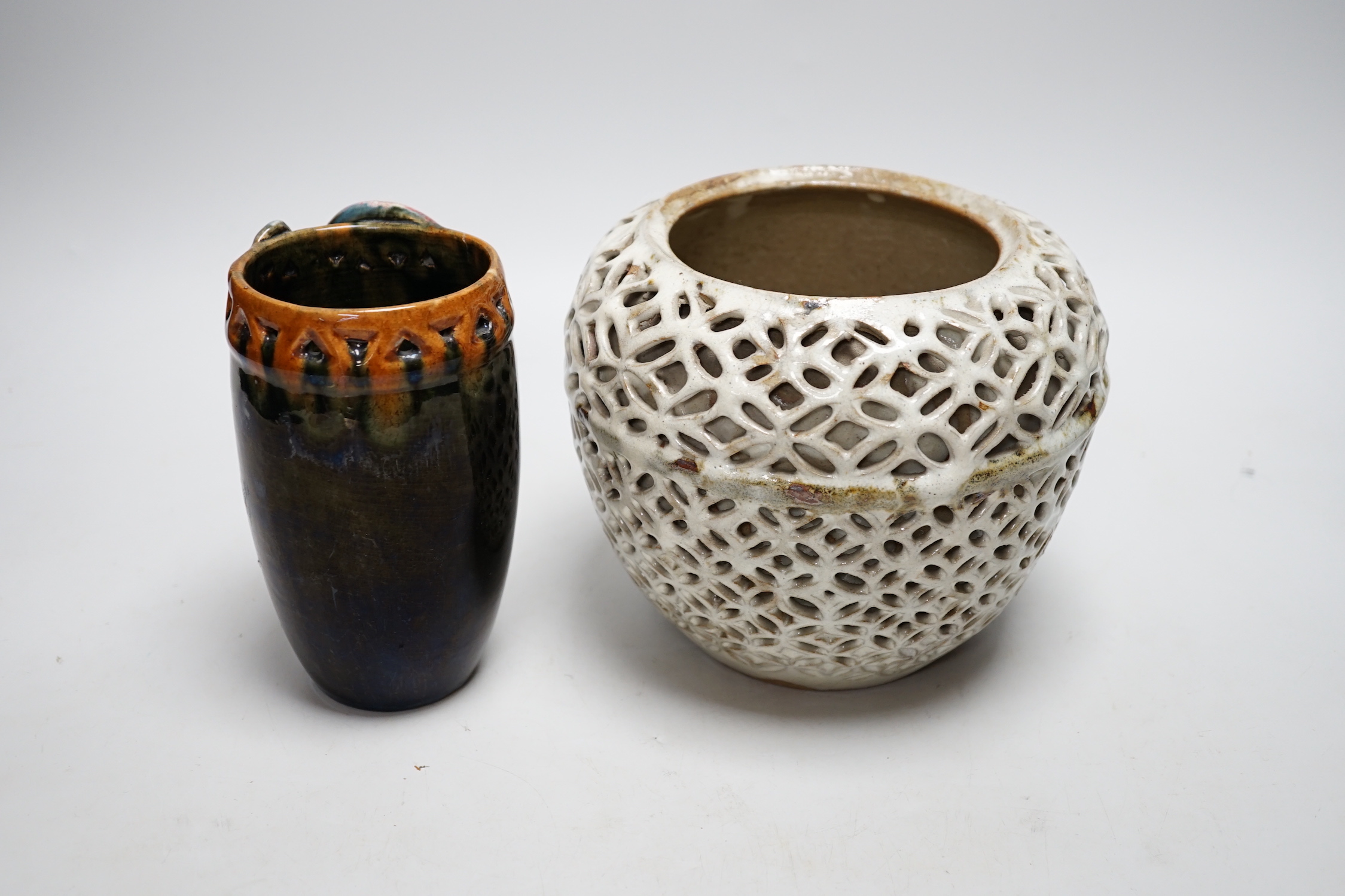 A reticulated art pottery vase and another pottery vase, largest 15cm high